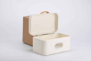 Classic white bread bin with wooden handle and clear viewing window on a marble kitchen counter.