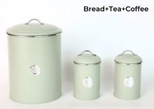A sage green bread bin with a subtle badge and two matching sage green canisters for tea and coffee, all with airtight seals to preserve freshness.