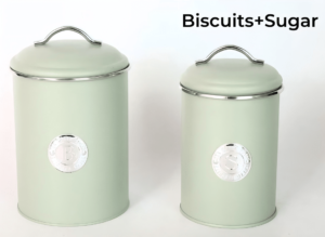 A set of sage green kitchen canisters, including an airtight biscuit tin, arranged on a countertop.