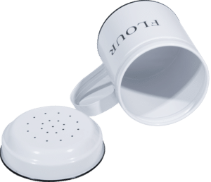 Close-up view of the perforated top of the flour shaker with a removable lid.