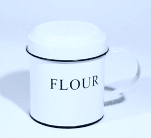 Flour shaker made of galvanized steel with a perforated top, perfect for baking or dusting flour.