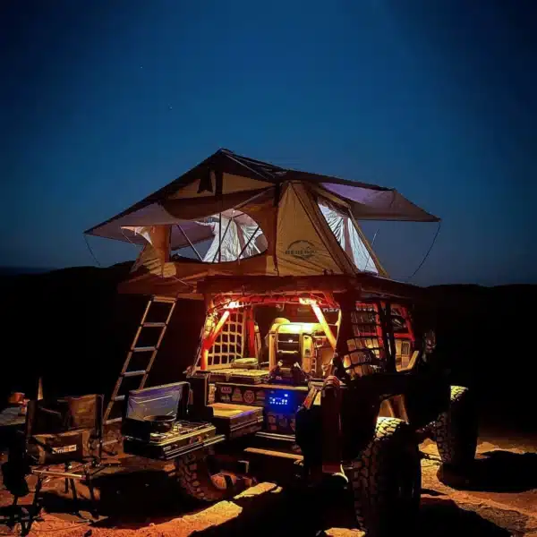 A beige and grey roof top tent with an extended awning, featuring a large window