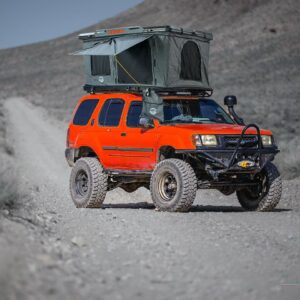 Roof top tent mounted on an off-road SUV with ladder access
