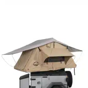 A beige and grey roof top tent with an extended awning, featuring a large window